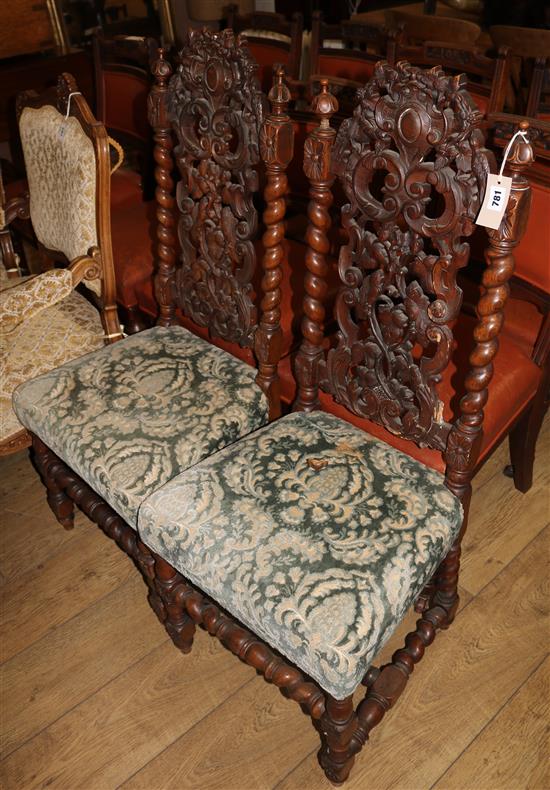 A pair of 19th century Flemish style carved walnut dining chairs